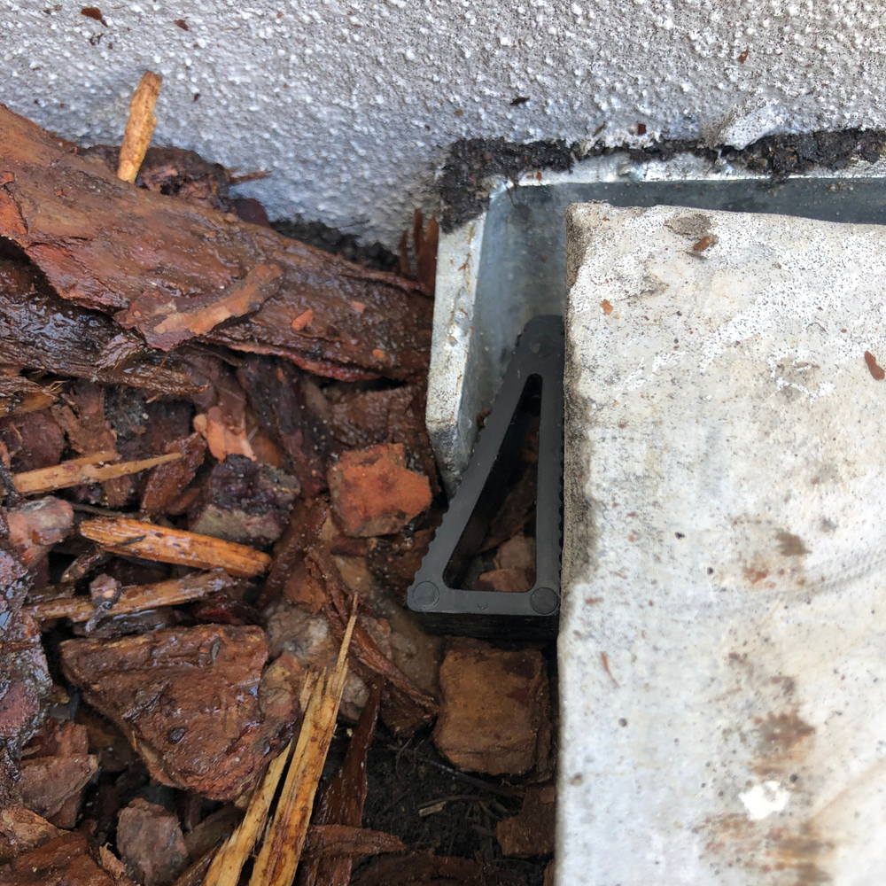 CLIP-IT® retainer wedge fitted beside a concrete sleeper and retaining wall post